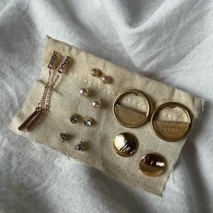 Multiple stud earrings.